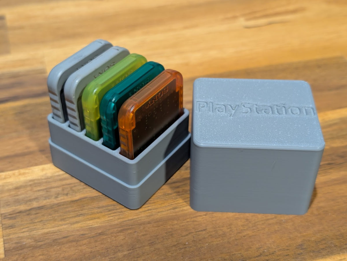 Open gray memory card case holding colored memory cards next to its lid