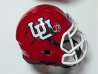 Mini football helmet wall mount holding a red helmet