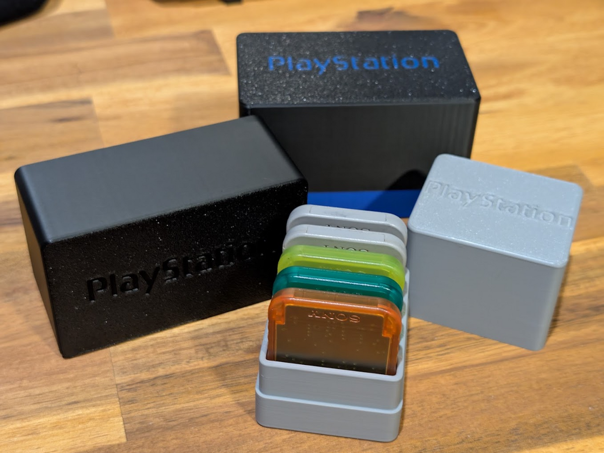 Black and gray memory card storage cases with an open case showing colored memory cards
