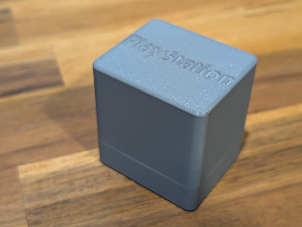 Closed gray memory card storage case with embossed lettering